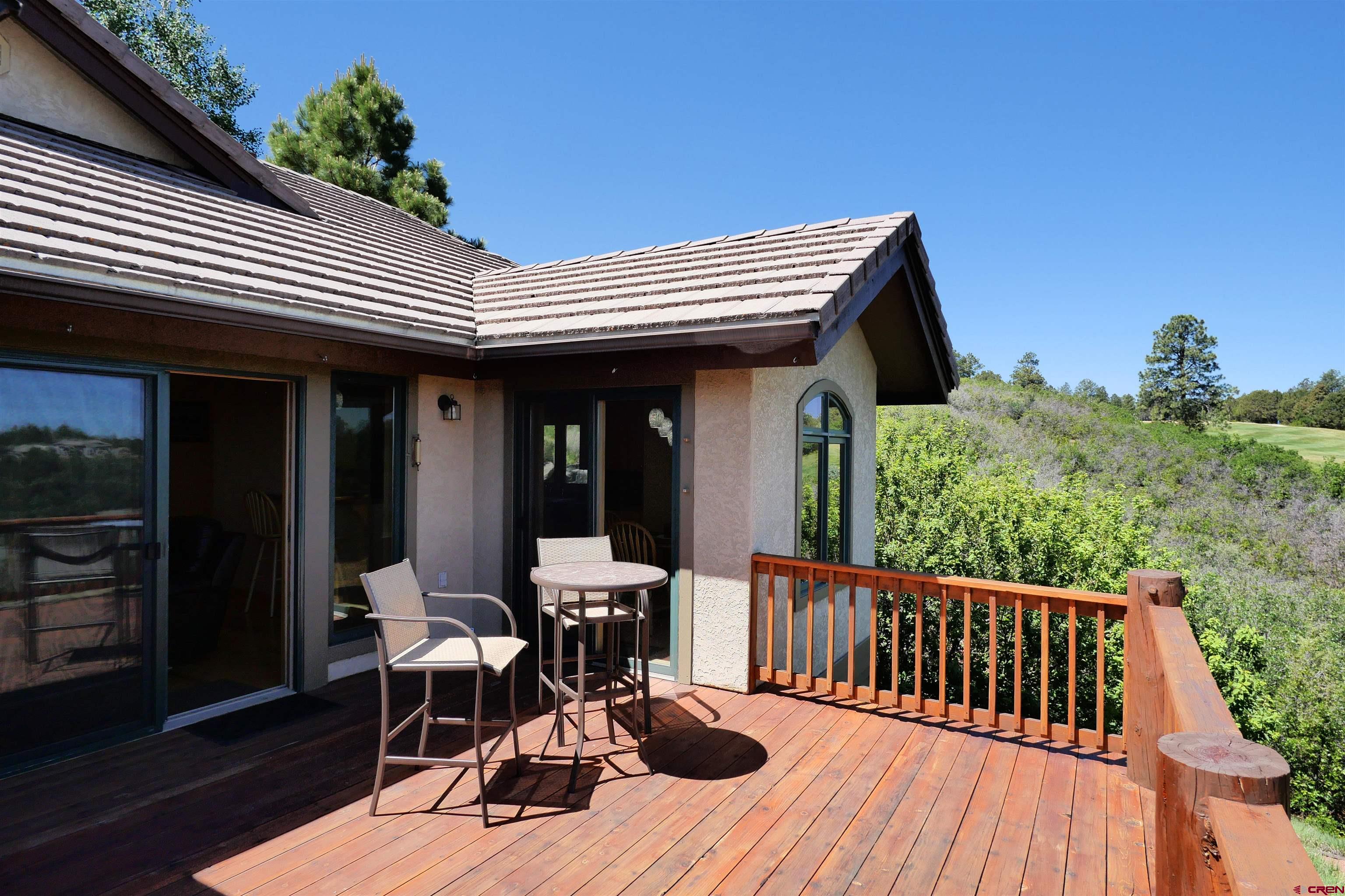 201 Woodchuck Place Ridgway, CO 81432 - Photo 18 of 33 a view of a patio with table and chairs with wooden floor and fence
