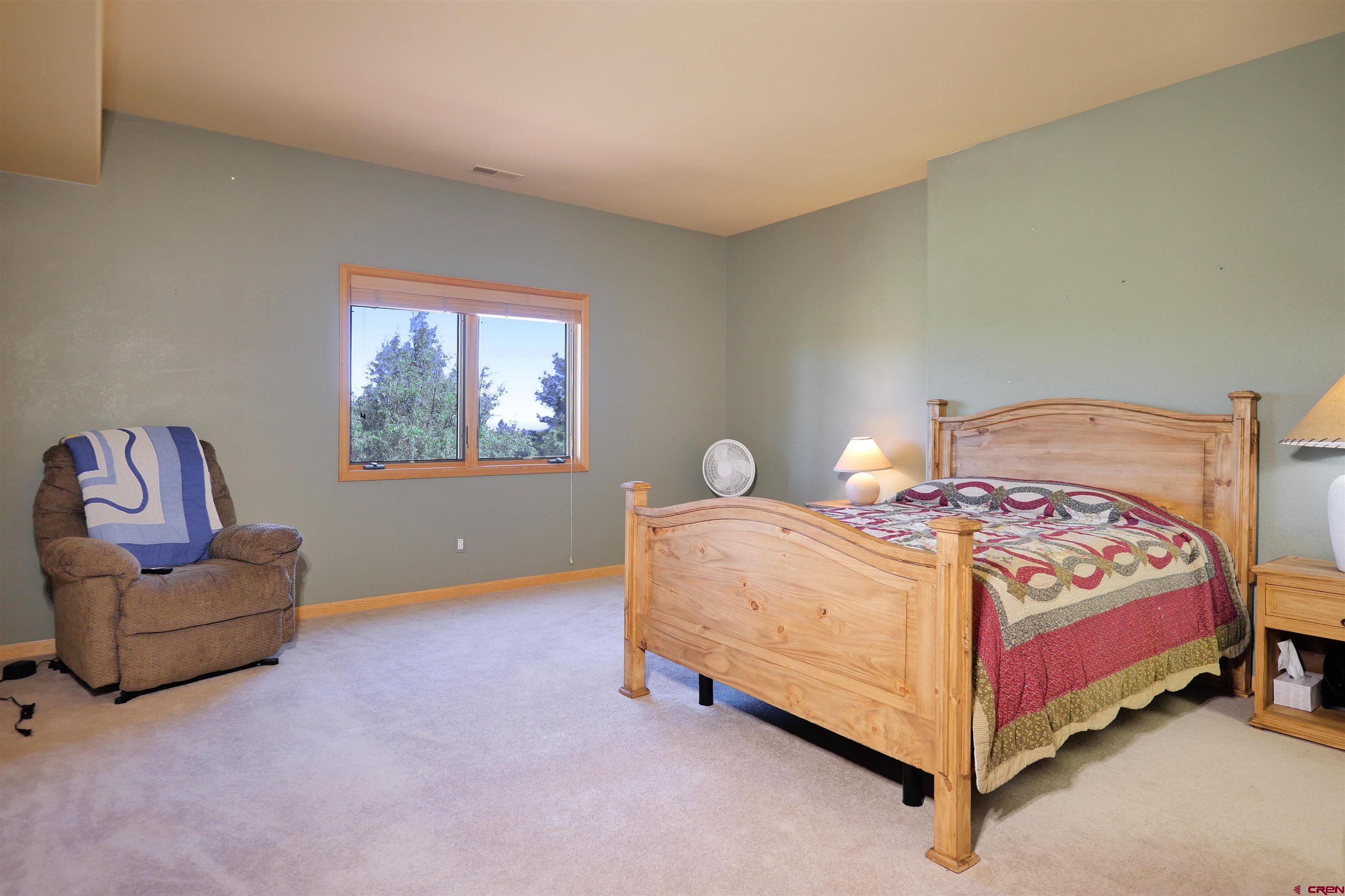 201 Woodchuck Place Ridgway, CO 81432 - Photo 27 of 33 a bedroom with a bed and a couch
