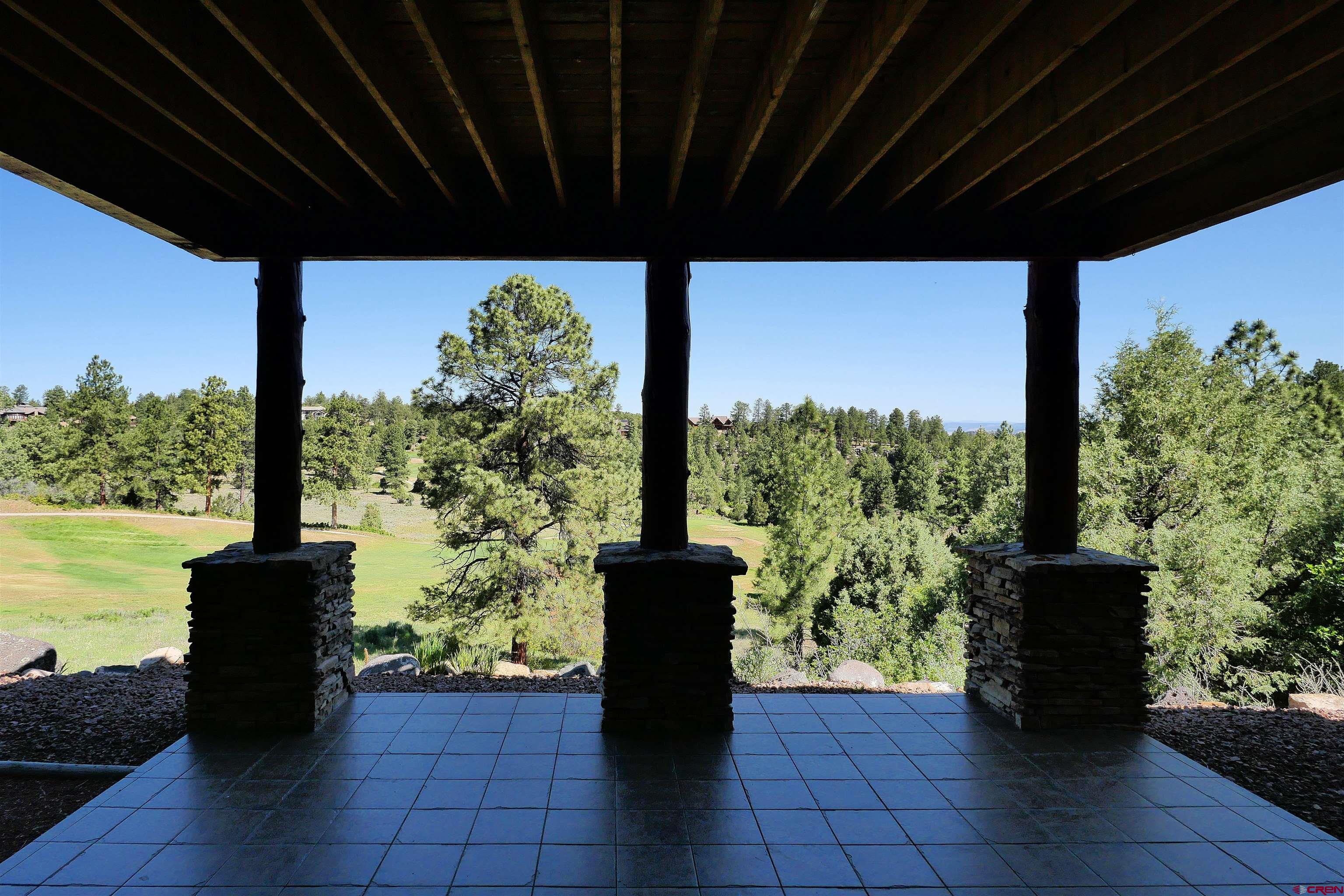201 Woodchuck Place Ridgway, CO 81432 - Photo 33 of 33 a view of a porch with wooden floor and roof with a garden