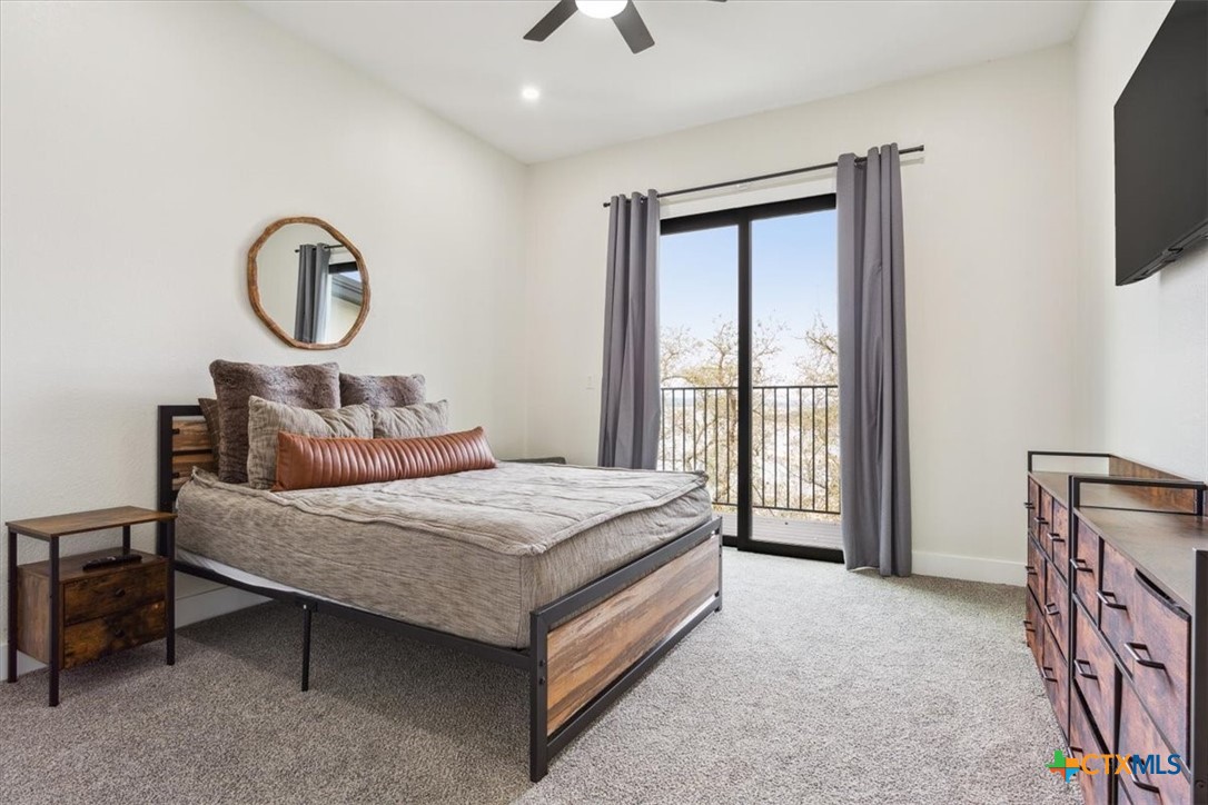 4802 Elf Trail Belton, TX 76513 - Photo 25 of 48 a bedroom with a bed a flat screen tv and balcony