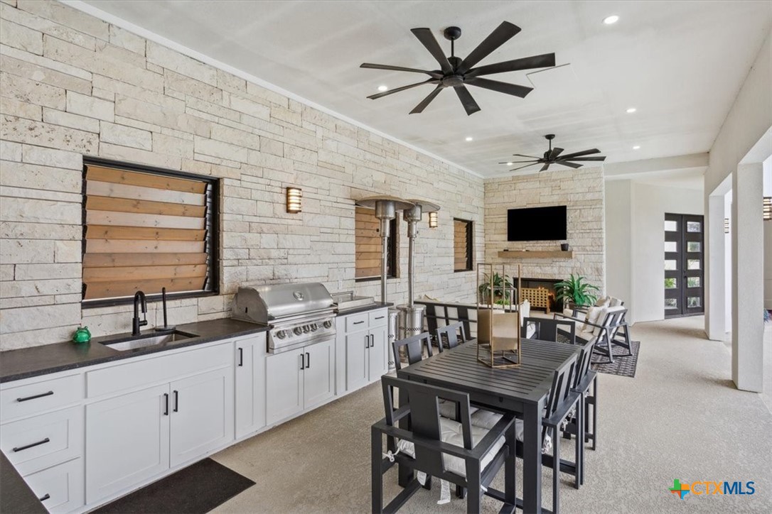 4802 Elf Trail Belton, TX 76513 - Photo 39 of 48 a kitchen with stainless steel appliances a stove a sink a dining table and chairs