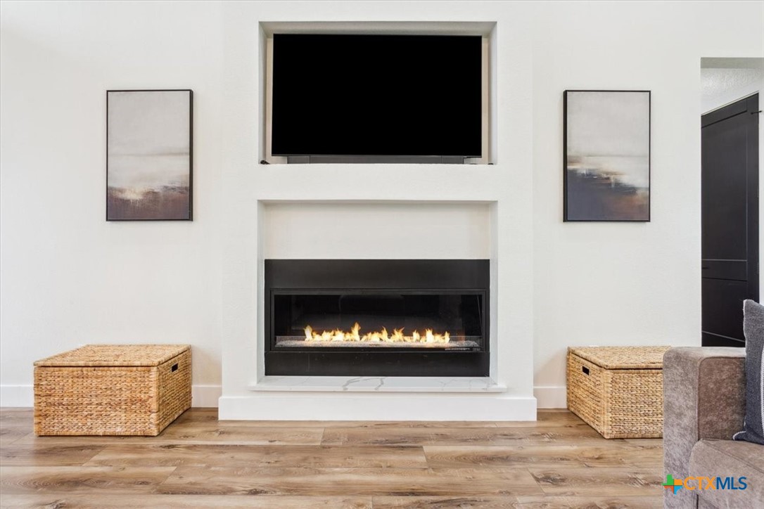 4802 Elf Trail Belton, TX 76513 - Photo 8 of 48 a living room with a fireplace and a flat screen tv