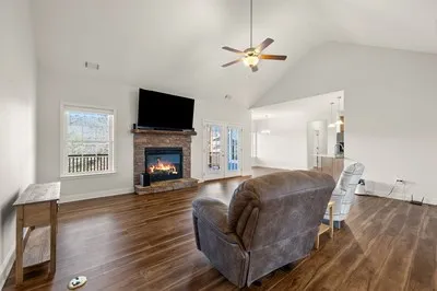 a kitchen with stainless steel appliances granite countertop a refrigerator a stove and a sink