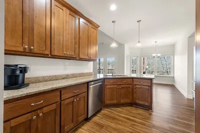 a bed sitting in a spacious bedroom next to a window
