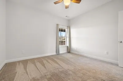 a living room with a bed and a window