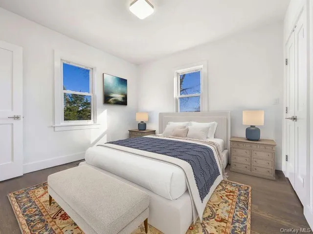 a bedroom with a bed and a lamp with wooden floor