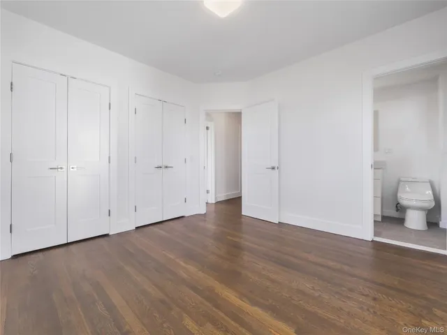 a view of an empty room and wooden floor