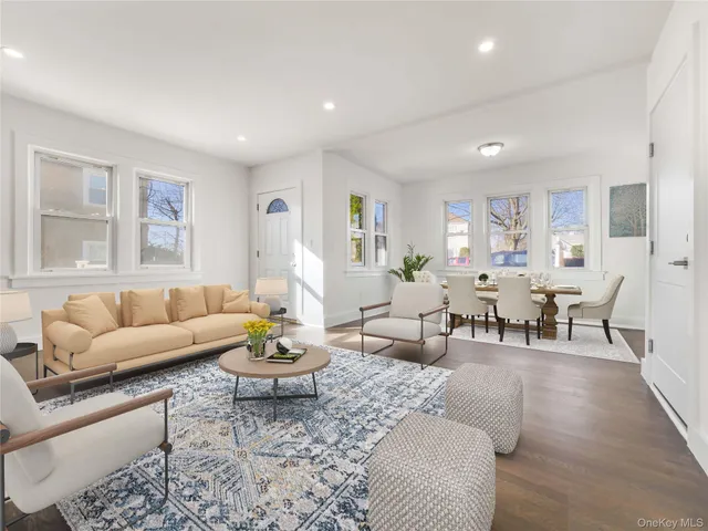 a living room with furniture a rug and a table