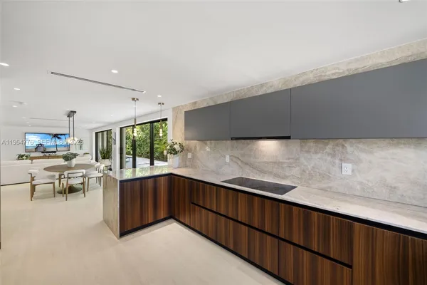 a kitchen with granite countertop a sink and cabinets
