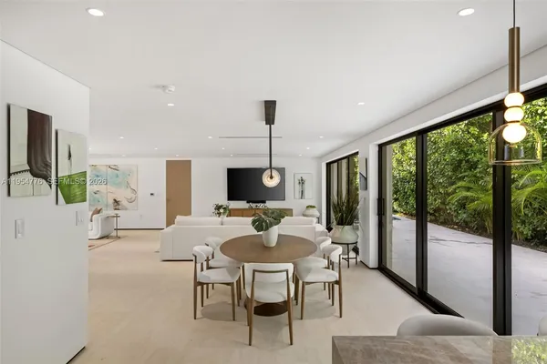 a living room with furniture a flat screen tv and a large window