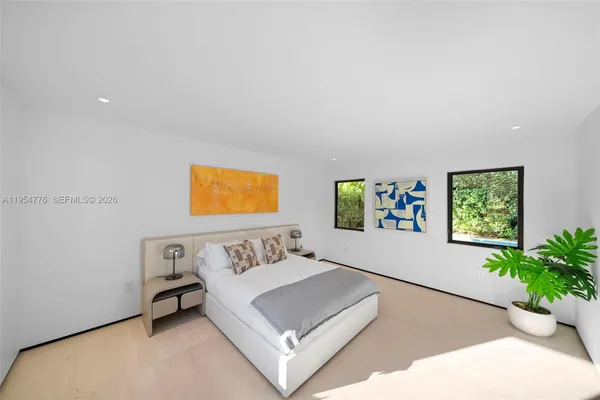 a living room with furniture and flowers