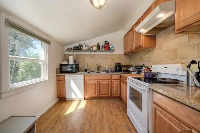 a kitchen with sink cabinets and window