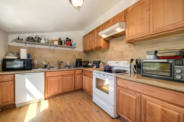 a living room with furniture and a book shelf