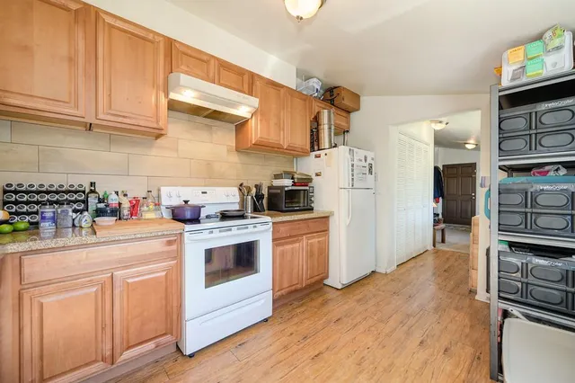 a bathroom with a sink a toilet and shower curtain