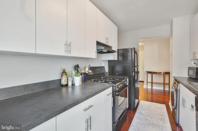 a kitchen with stainless steel appliances granite countertop a sink and a refrigerator