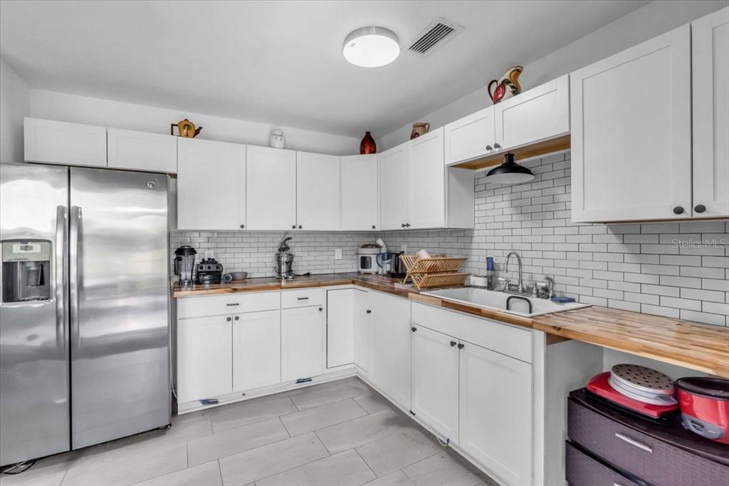2211 Englewood Road Englewood, FL 34223 - Photo 18 of 86 a kitchen with cabinets stainless steel appliances and a sink