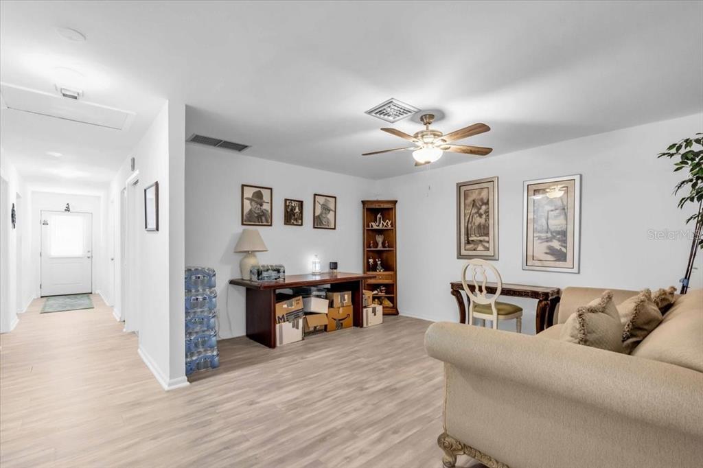 2211 Englewood Road Englewood, FL 34223 - Photo 36 of 86 a living room with furniture and wooden floor
