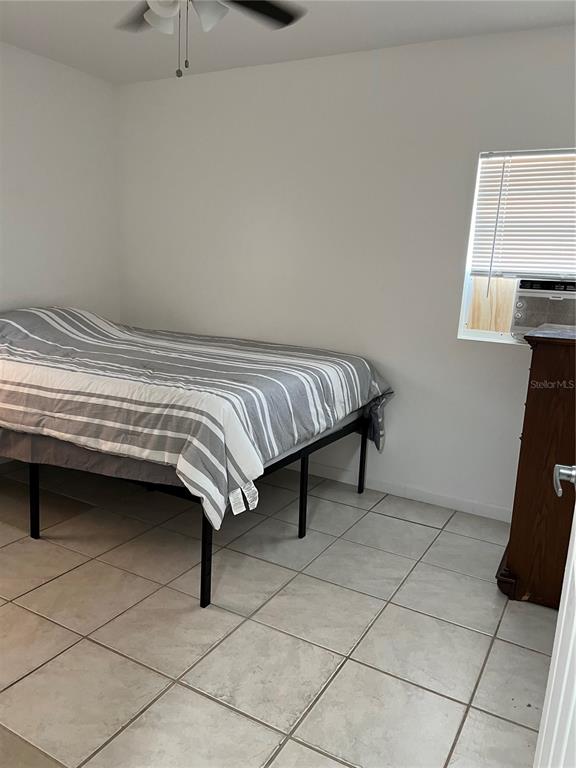 2211 Englewood Road Englewood, FL 34223 - Photo 75 of 86 a bedroom with a bed and a window