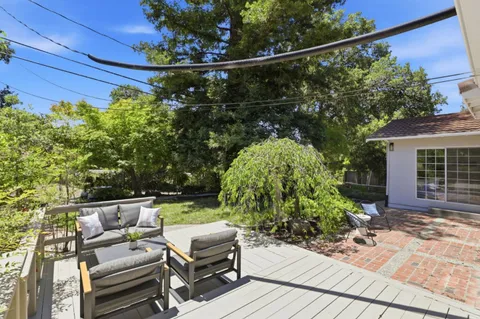 a view of yard from deck with seating space