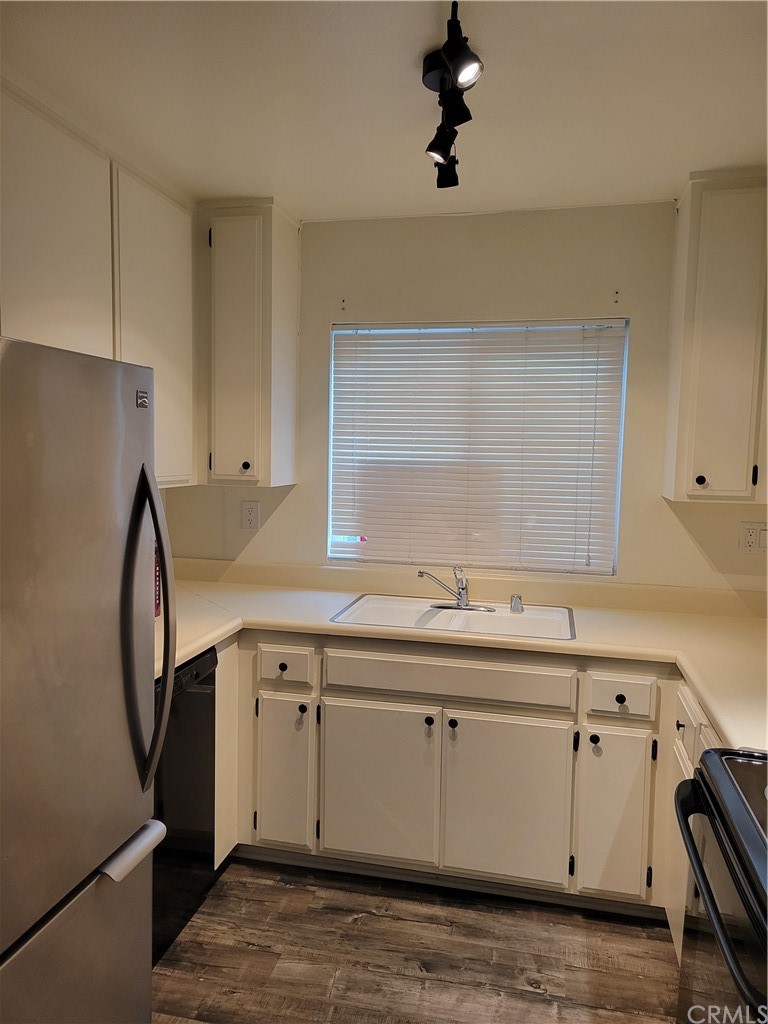34026 Selva Road, Unit 68 Dana Point, CA 92629 - Photo 5 of 16 a kitchen with a sink appliances and cabinets