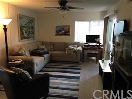 34026 Selva Road, Unit 68 Dana Point, CA 92629 - Photo 7 of 16 a living room with furniture and a flat screen tv