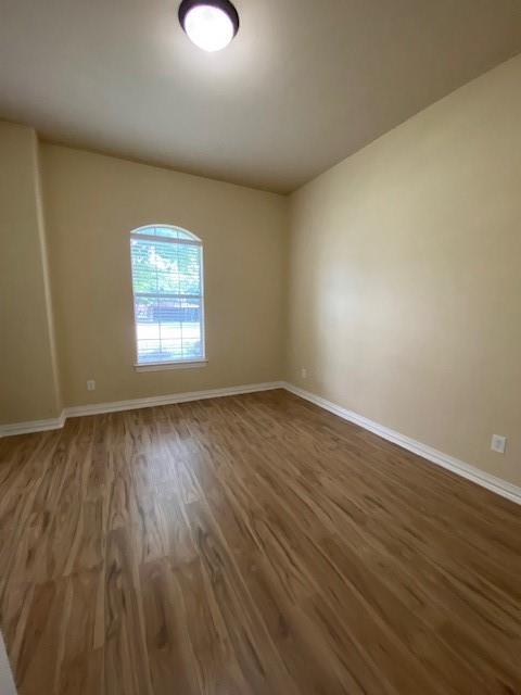 4952 Stephanie Street Frisco, TX 75033 - Photo 13 of 21 an empty room with wooden floor and windows