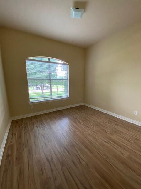 4952 Stephanie Street Frisco, TX 75033 - Photo 15 of 21 an empty room with wooden floor and windows