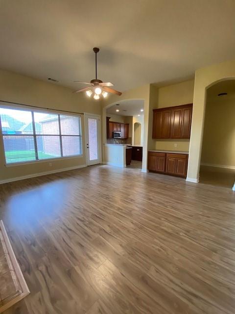 4952 Stephanie Street Frisco, TX 75033 - Photo 6 of 21 an empty room with wooden floor chandelier and windows