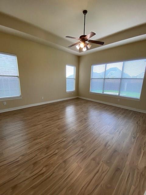 4952 Stephanie Street Frisco, TX 75033 - Photo 10 of 21 a view of an empty room with wooden floor and a window