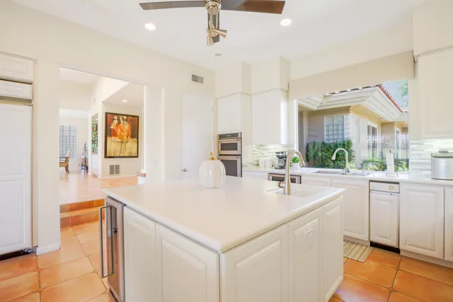 a kitchen with stainless steel appliances a sink and a refrigerator
