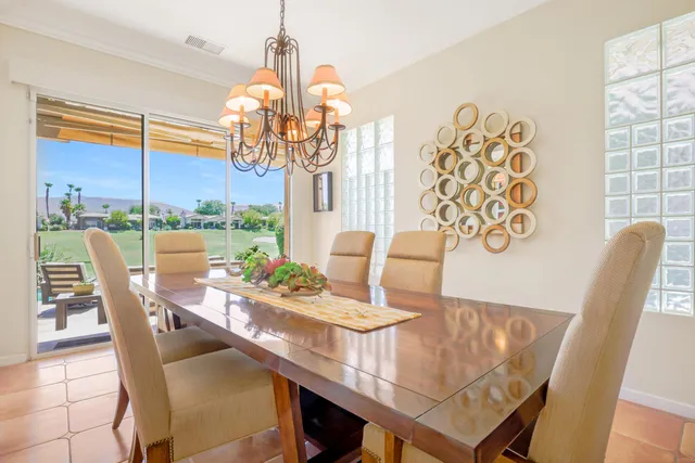 a dining room with furniture and a chandelier