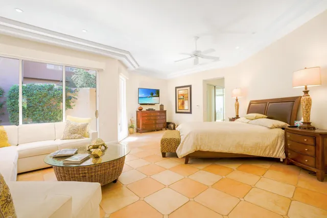 a bedroom with a bed and glass window