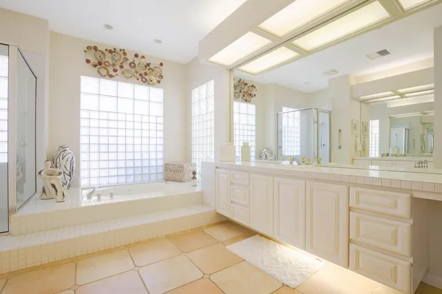 a large white kitchen with a large window