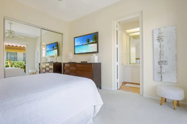 a spacious bedroom with a bed and a couch