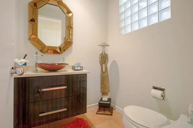 a bathroom with a sink mirror vanity and toilet