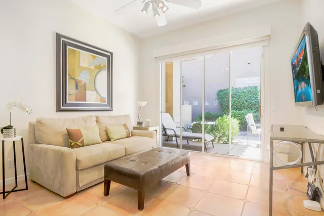 a living room with furniture and large windows