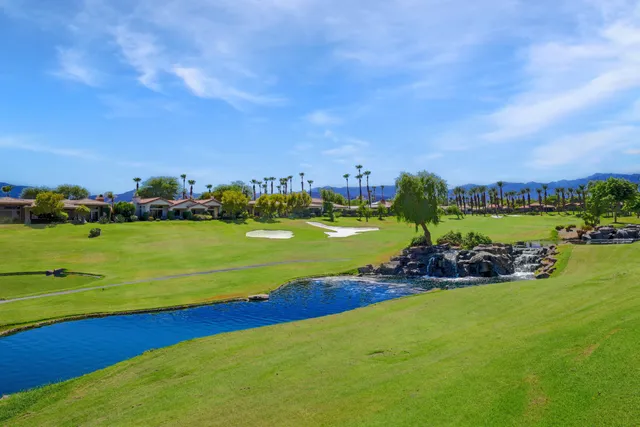 a view of a lake with houses in the back