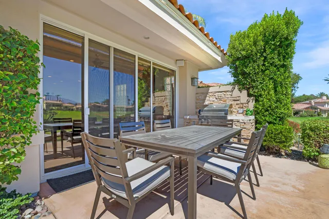 a view of a patio with table and chairs and potted plants