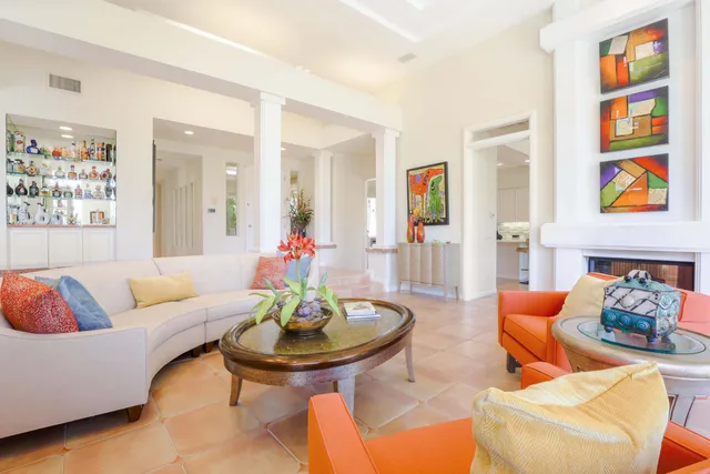 a living room with furniture and painting on the wall