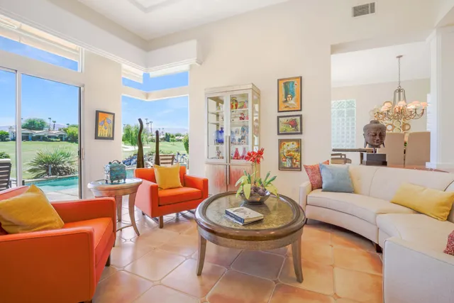 a living room with furniture and a floor to ceiling window