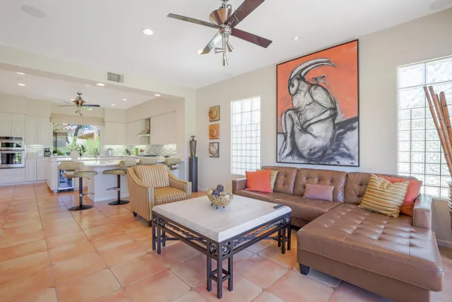 a living room with furniture and kitchen view