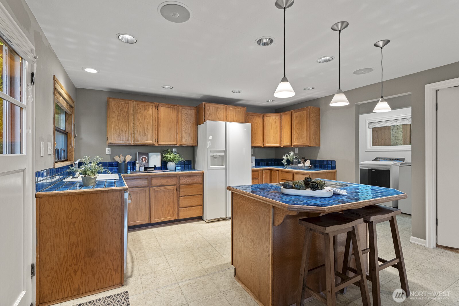 7727 Lake Alice Road Southeast Fall City, WA 98024 - Photo 10 of 34 a kitchen with stainless steel appliances kitchen island granite countertop a table chairs and a window