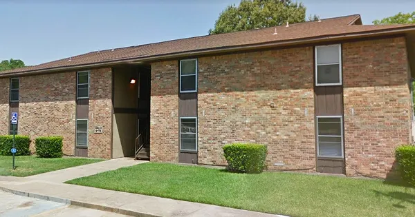 a view of a brick house with a large windows