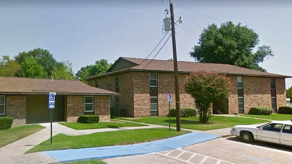 a car parked in front of a house and a yard