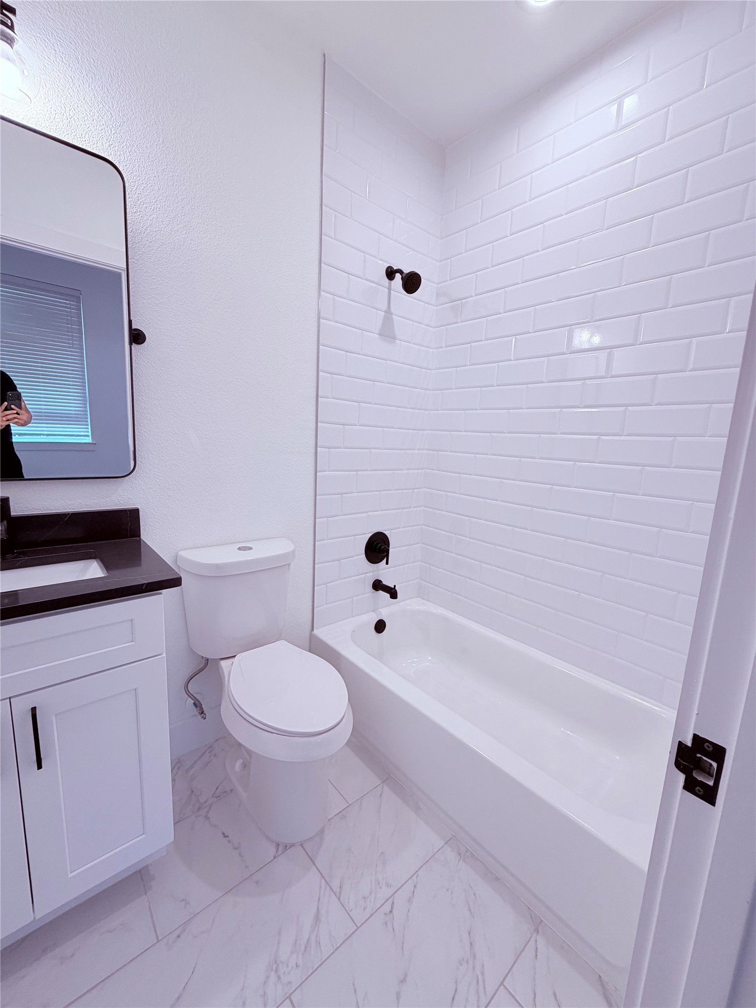 1417 Kramer Lane, Unit 7 Austin, TX 78758 - Photo 5 of 24 White subway tile adorns the bath in this updated, naturally illuminated private bath.