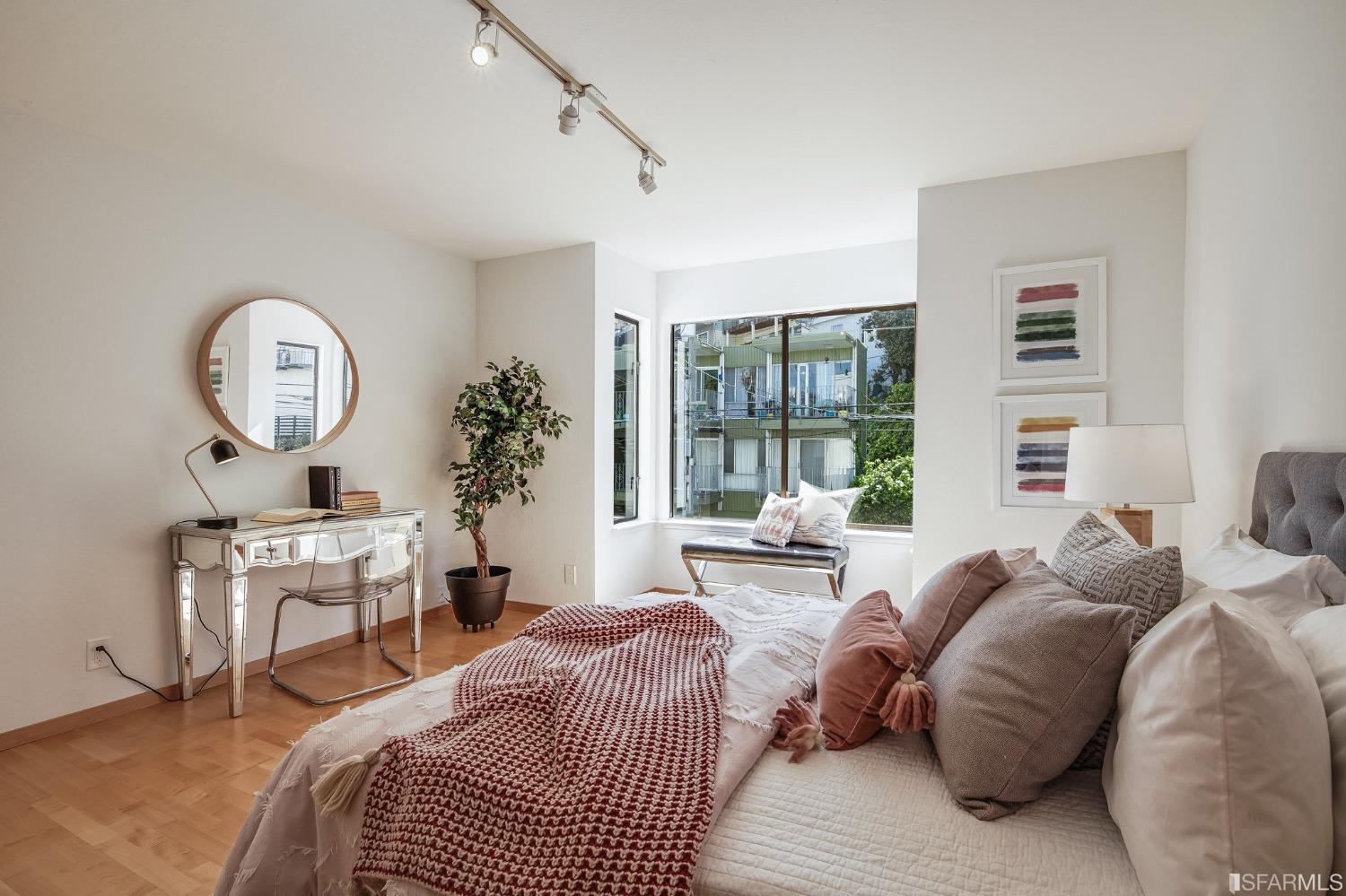138 Corwin Street San Francisco, CA 94114 - Photo 30 of 60 a bedroom with a bed a mirror and a large window