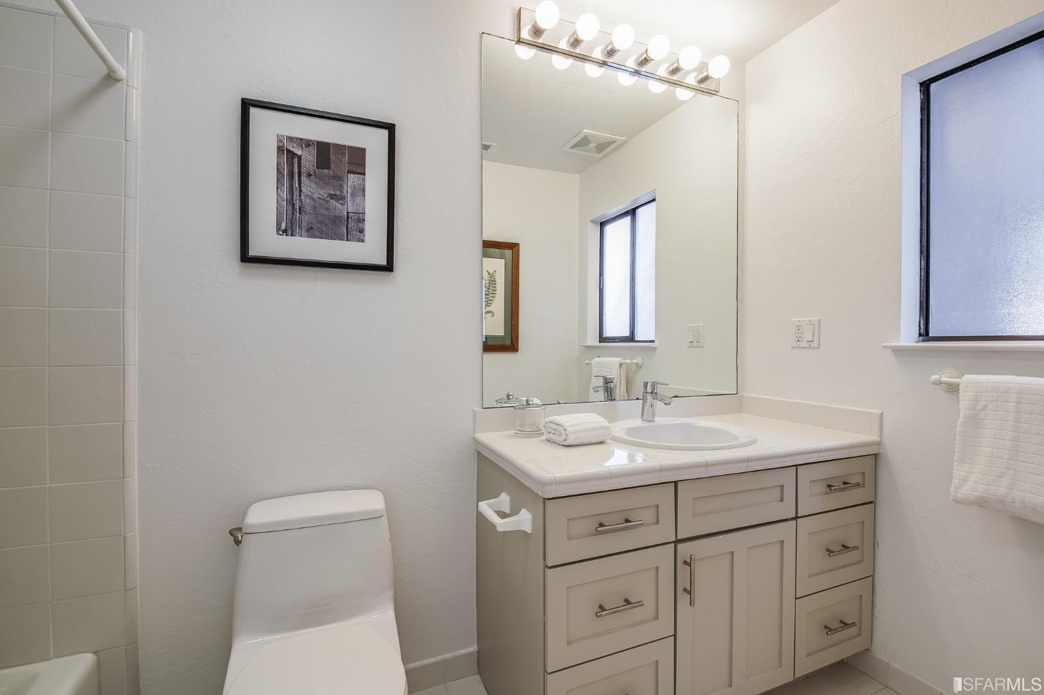 138 Corwin Street San Francisco, CA 94114 - Photo 33 of 60 a bathroom with a toilet sink and mirror
