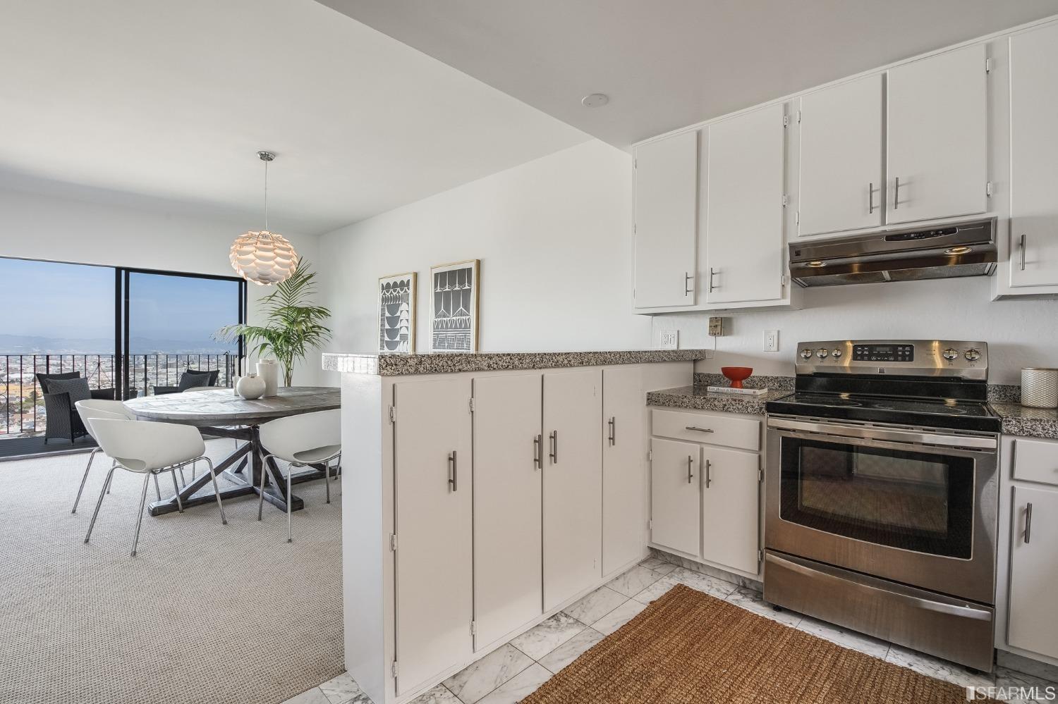 138 Corwin Street San Francisco, CA 94114 - Photo 40 of 60 a kitchen with stainless steel appliances a stove a sink cabinets and a dining table