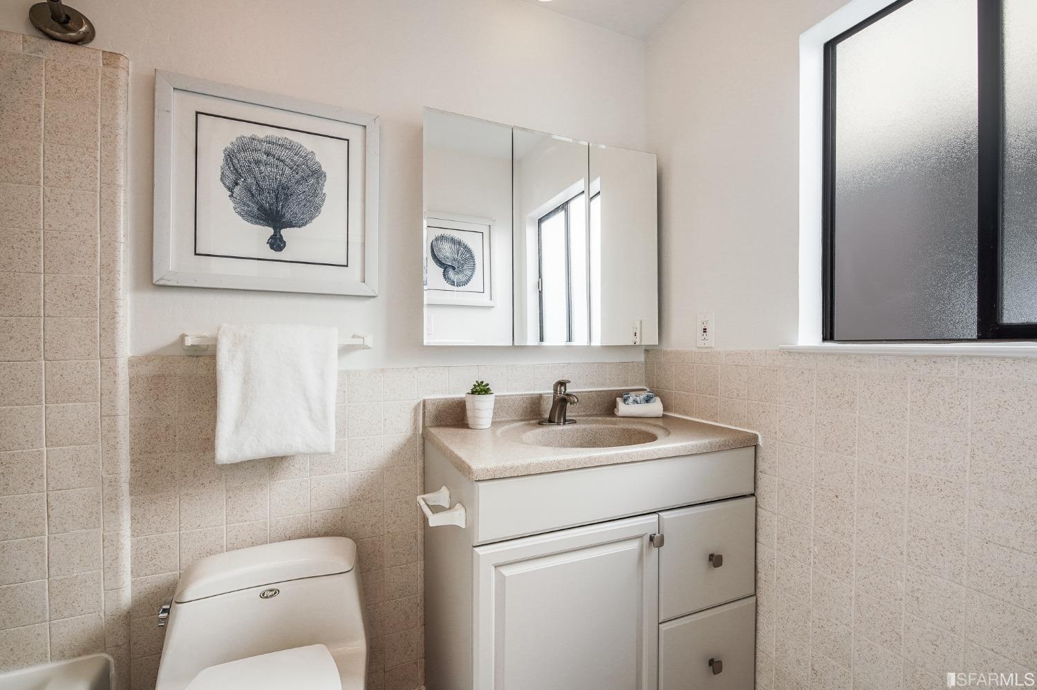 138 Corwin Street San Francisco, CA 94114 - Photo 43 of 60 a bathroom with a toilet sink and mirror