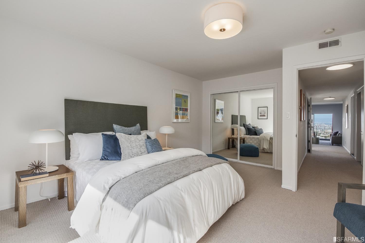 138 Corwin Street San Francisco, CA 94114 - Photo 45 of 60 a spacious bedroom with a bed and a lamp